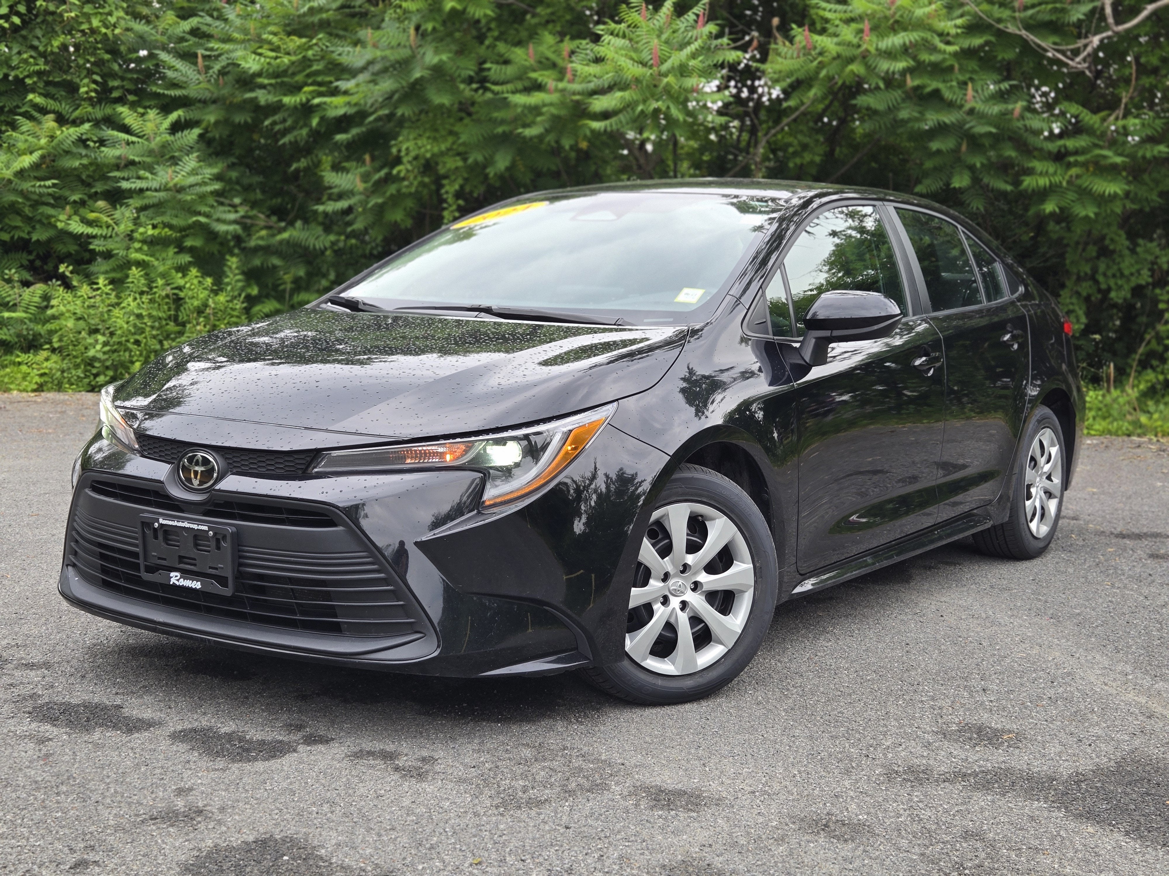 2024 Toyota Corolla LE in Midnight Black Metallic — front three-quarter view