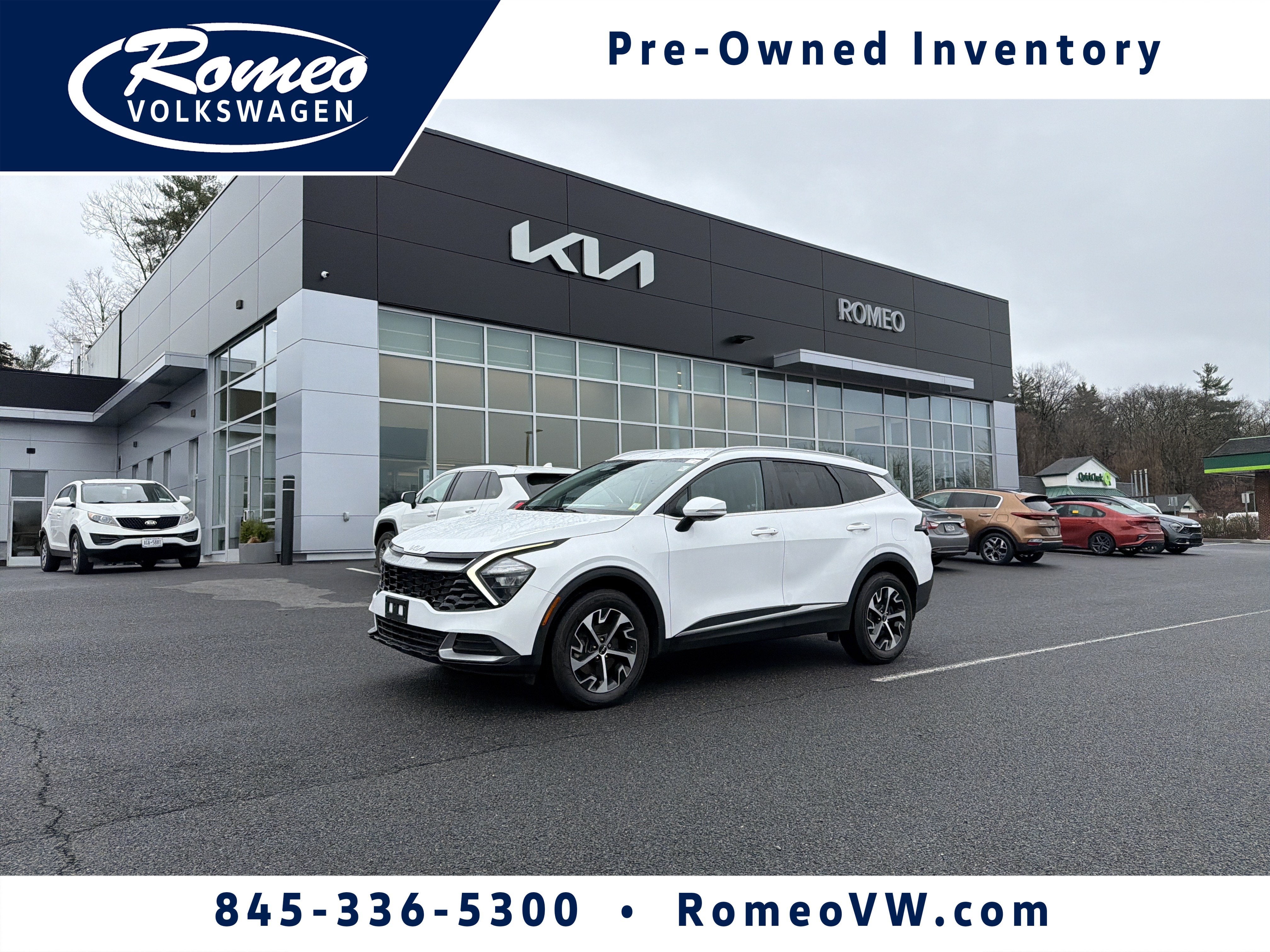 2023 Kia Sportage EX in Glacial White Pearl — front three-quarter view