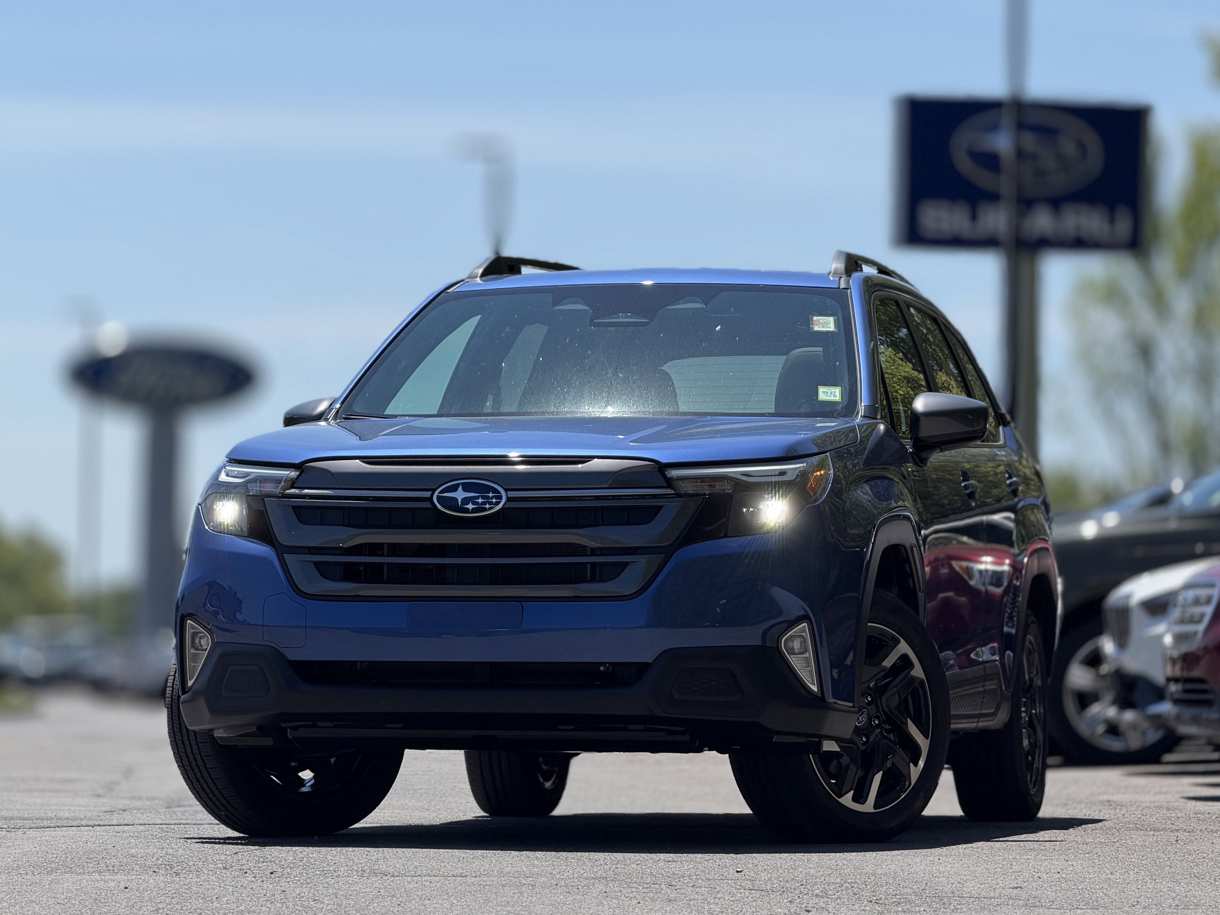 2026 Subaru FORESTER Premium Hybrid in Daybreak Blue Pearl — front three-quarter view