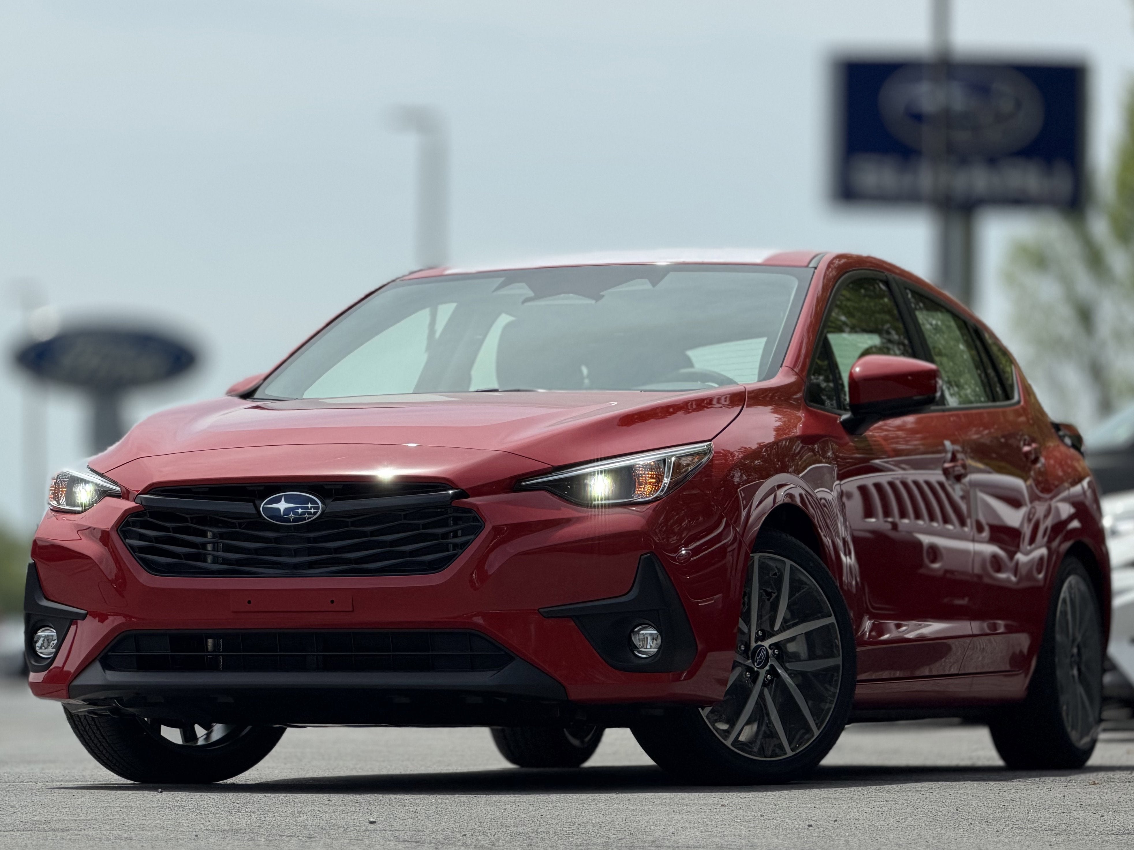 2026 Subaru IMPREZA Sport in Pure Red — front three-quarter view