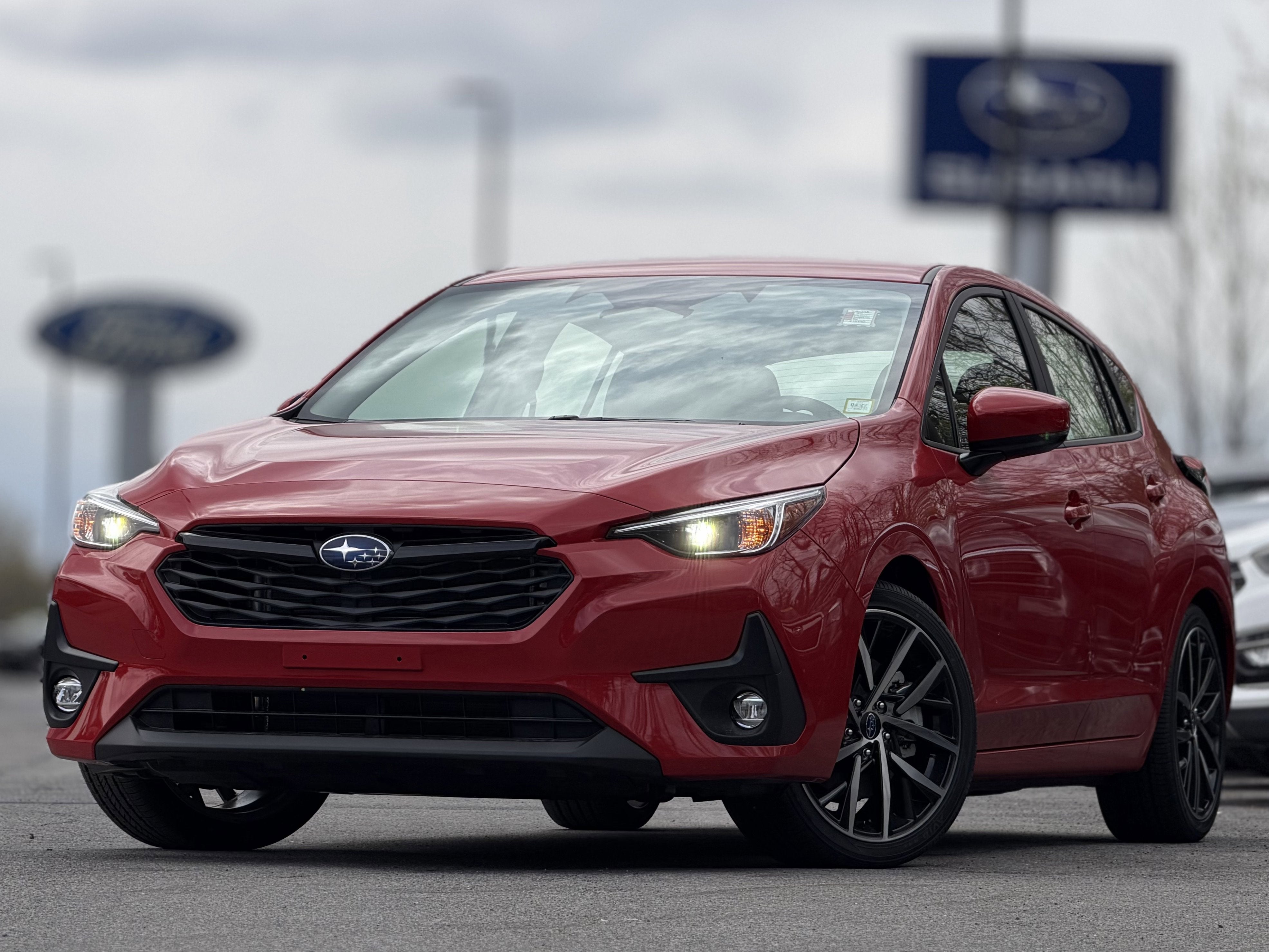 2026 Subaru IMPREZA Sport in Pure Red — front three-quarter view