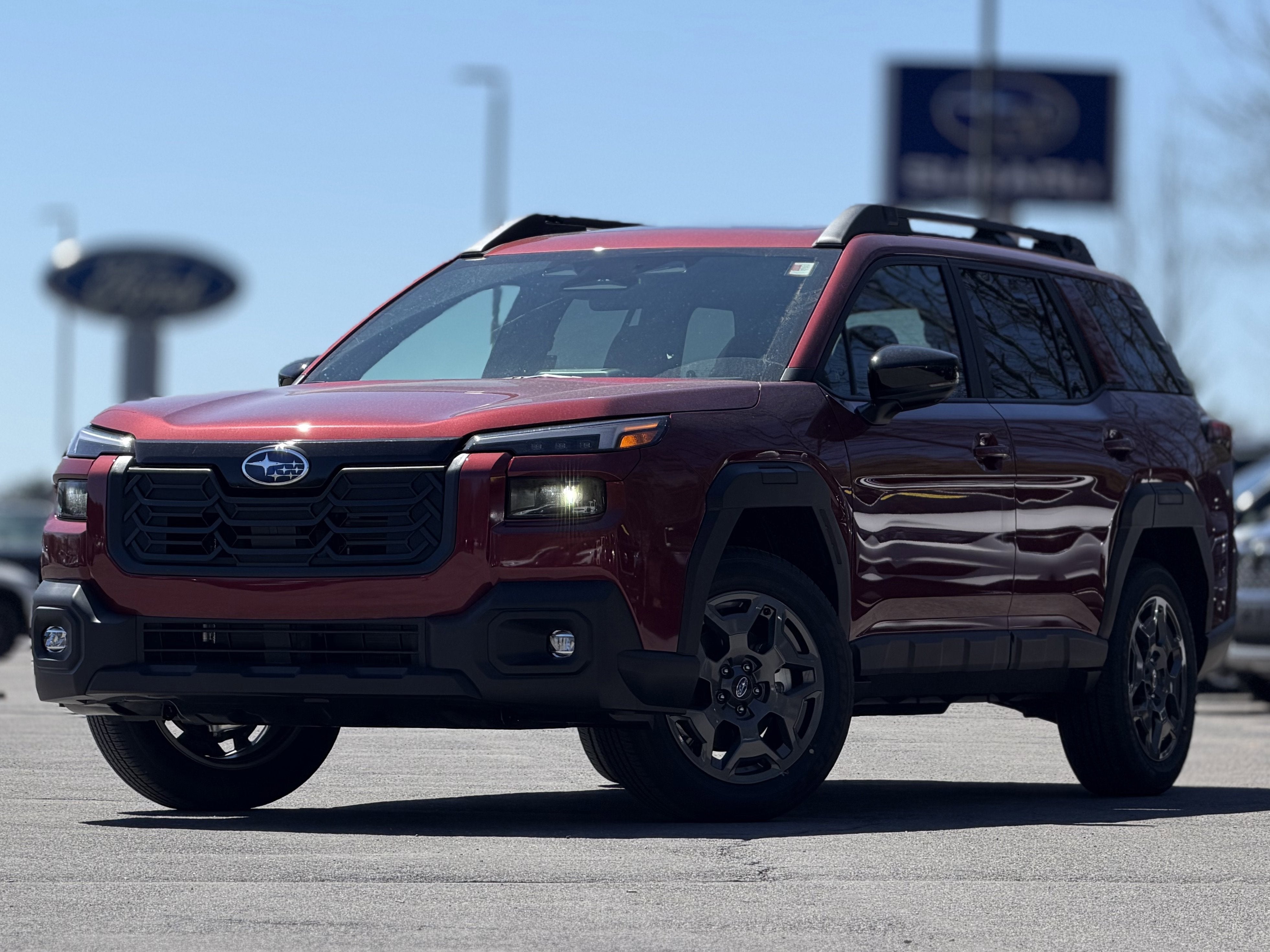 2026 Subaru OUTBACK Premium in Crimson Red Pearl — front three-quarter view
