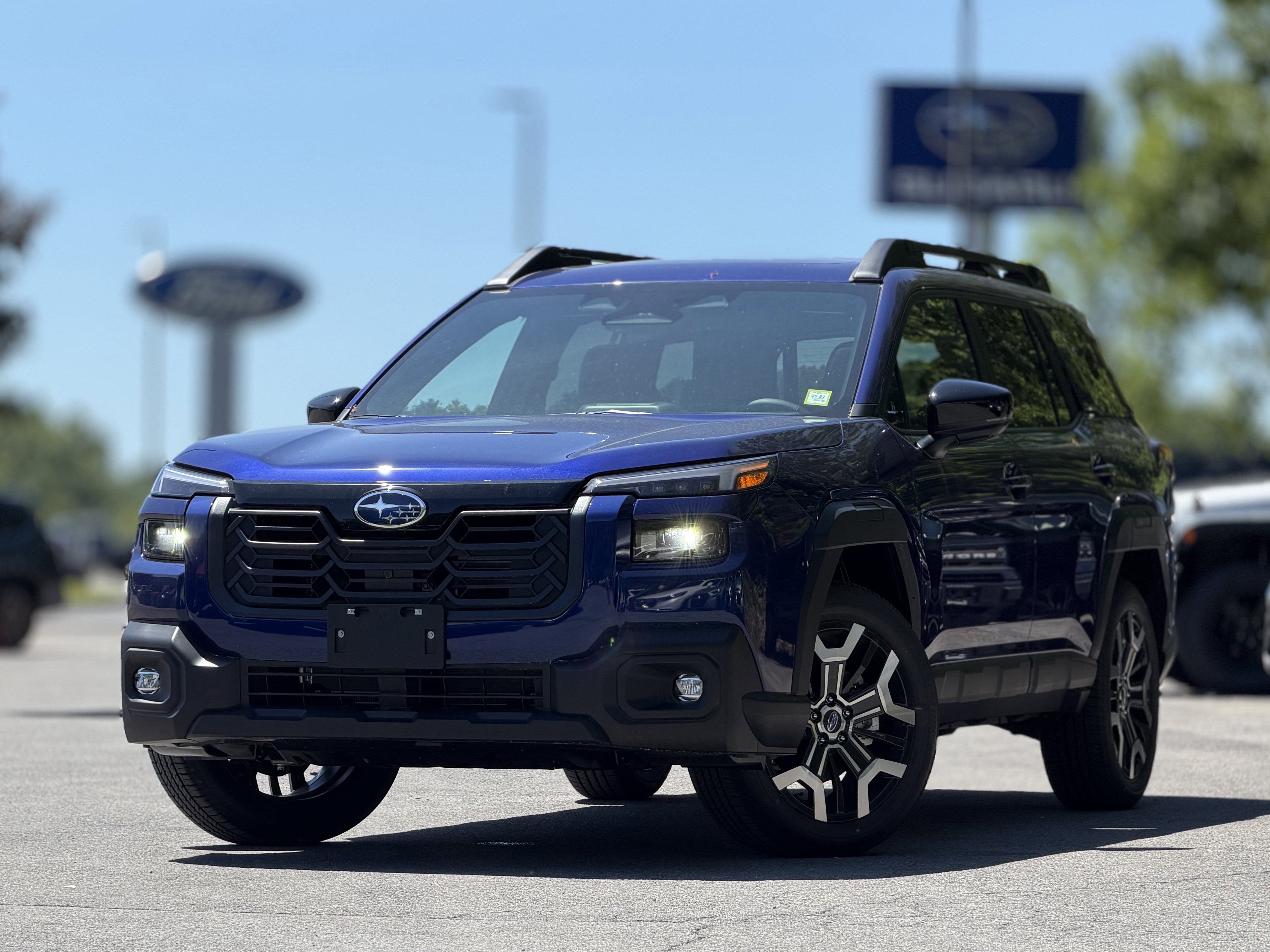 2026 Subaru OUTBACK Touring XT in Sapphire Blue Pearl — front three-quarter view